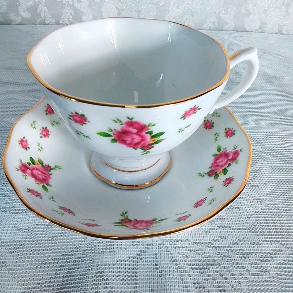 Vintage Royal Albert floral teacup and saucer set with gold trim from England